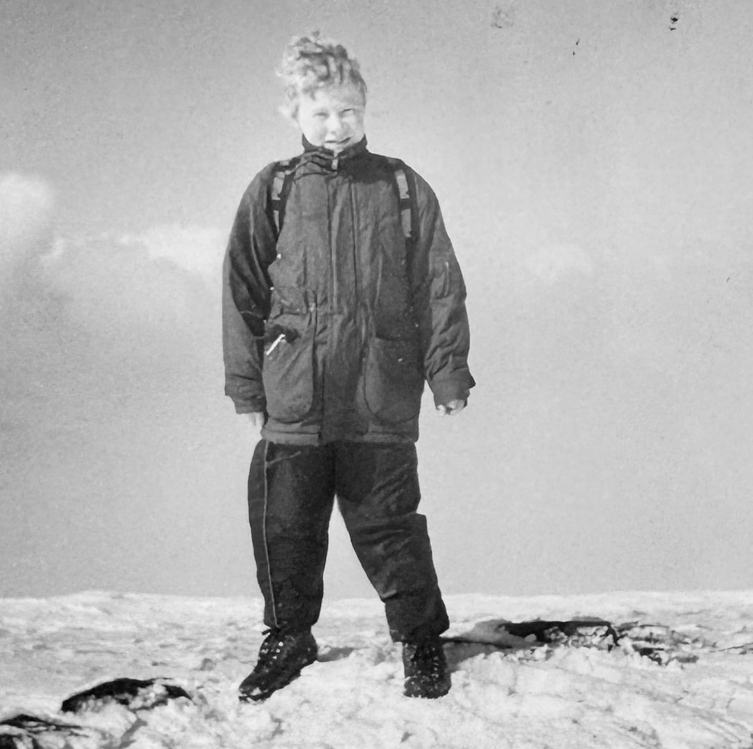 Childhood photo of Daniel Bellerby wearing snow gear on a mountainside, reflecting his lifelong interest in the outdoors